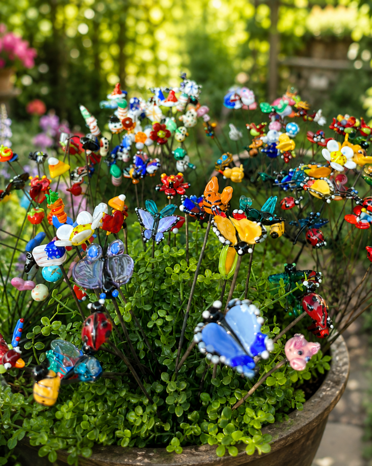 Colorful handmade glass plant sticks displayed in a garden planter