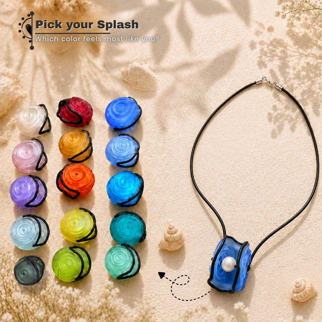 A necklace with a black cord and a blue rose-shaped pendant featuring a white pearl, displayed on a sandy background next to multiple color options of matching rose-shaped beads. Text on the image reads 'Pick your Splash'.